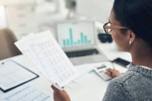 Female certified public accountant providing attest services for her client. Attestation Services are provided by Brown, Chism & Thompson in Tulsa.