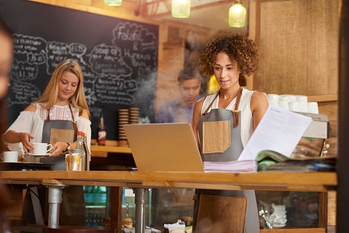 Lady in coffee shop needing bookkeeping services.