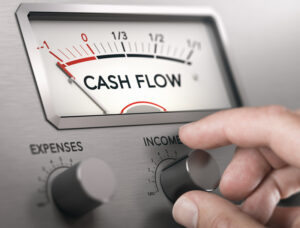 Cash Flow Crisis Concept. Man turning knob to increase income and cash flow level.. Survive a cash flow crisis - Brown Chism Thompson