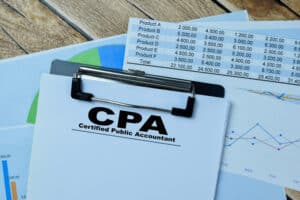 Concept of CPA - Certified Public Accountant write on paperwork isolated on Wooden Table-Certified Public Accountant Tulsa OK