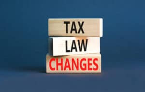 Tax law changes on wooden blocks on a beautiful grey table grey background. 2024 Tax Filing - Brown, Chism & Thompson.