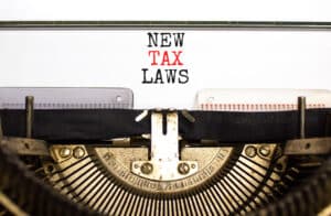 Concept words New tax laws typed on an old retro typewriter on a beautiful white paper background. Business new tax laws concept. Impact of New Tax Laws in 2025 - Brown, Chism & Thompson.